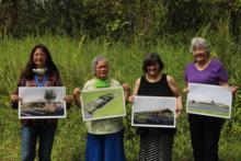 Community Center Action Committee holding artist renderings at the new site of the Orchidland community center